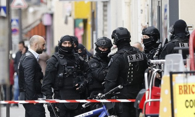 french members of the research and intervention brigade bri police unit stand guard at the bottom of a building photo afp french members of the research and intervention brigade bri police unit stand guard at the bottom of a building photo afp