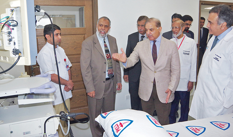 chief minister shehbaz sharif points to some of the medical equipment at the institute photo inp