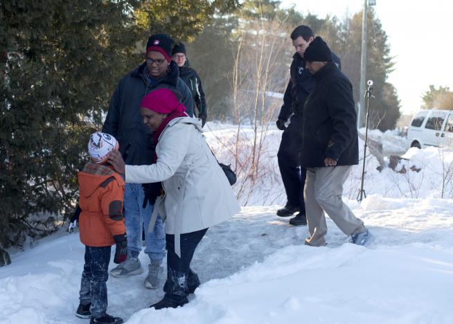 a family who claimed to be from sudan are met by royal canadian mounted police rcmp officers as they illegally cross the us canada border leading into hemmingford quebec canada march 20 2017 photo reuters