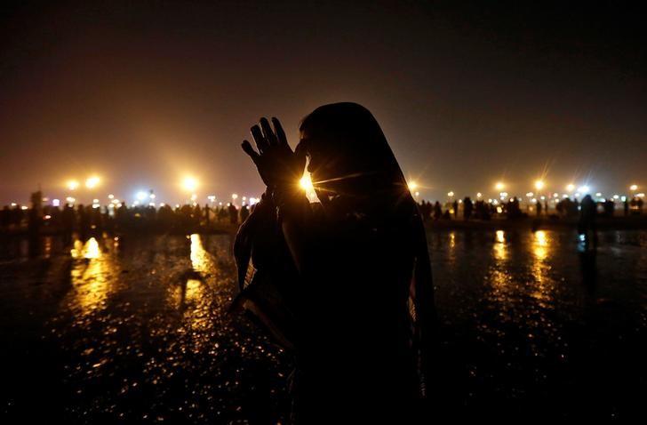 a hindu pilgrim offers prayers after taking a dip in the ganges river ahead of the one day festival of makar sankranti at sagar island south of kolkata india january 13 2017 photo reuters