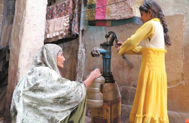 in search of potable water an elderly woman fills a container with water from a tap in karachi on world water day photo online in search of potable water an elderly woman fills a container with water from a tap in karachi on world water day photo online