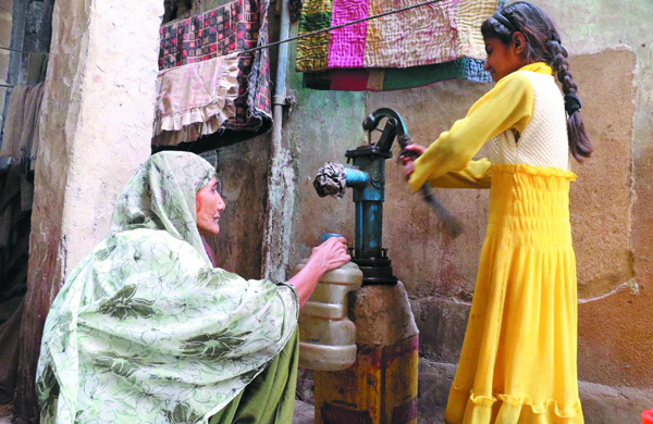 in search of potable water an elderly woman fills a container with water from a tap in karachi on world water day photo online