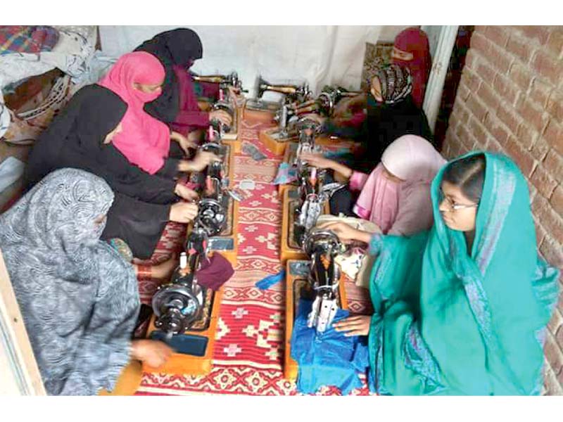 girls learning sewing skills at the vocational centre photo app