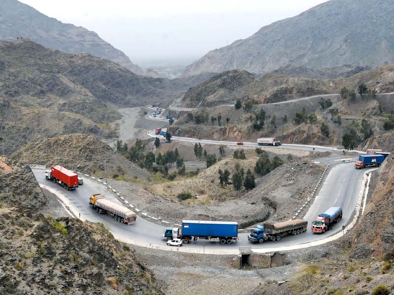 trucks and other vehicles travel in the mountainous region near torkham after the reopening of border with afghanistan photo afp