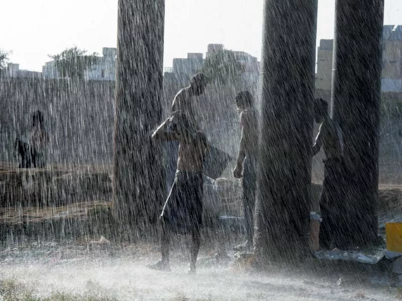 residents take a shower under a leaking water pipeline in karachi photo afp residents take a shower under a leaking water pipeline in karachi photo afp