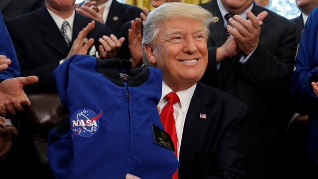 us president donald trump receives a nasa jacket during a signing ceremony for s442 the nasa transition authorization act in the oval office of the white house in washington photo reuters us president donald trump receives a nasa jacket during a signing ceremony for s442 the nasa transition authorization act in the oval office of the white house in washington photo reuters
