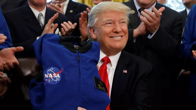 us president donald trump receives a nasa jacket during a signing ceremony for s442 the nasa transition authorization act in the oval office of the white house in washington photo reuters us president donald trump receives a nasa jacket during a signing ceremony for s442 the nasa transition authorization act in the oval office of the white house in washington photo reuters