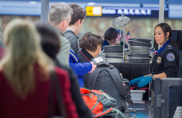 airline travelers are processed at a transportation safety agency tsa security checkpoint december 23 2014 at dulles international airport photo paul j richards afp