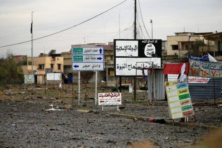 islamic state signs are seen on a street during a battle between iraqi forces and islamic state militants in mosul iraq march 16 2017 photo reuters