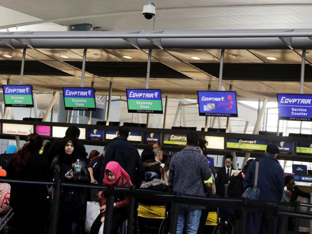 travellers wait to check in at an egypt air counter at jfk international airport in new york us march 21 2017 photo reuters