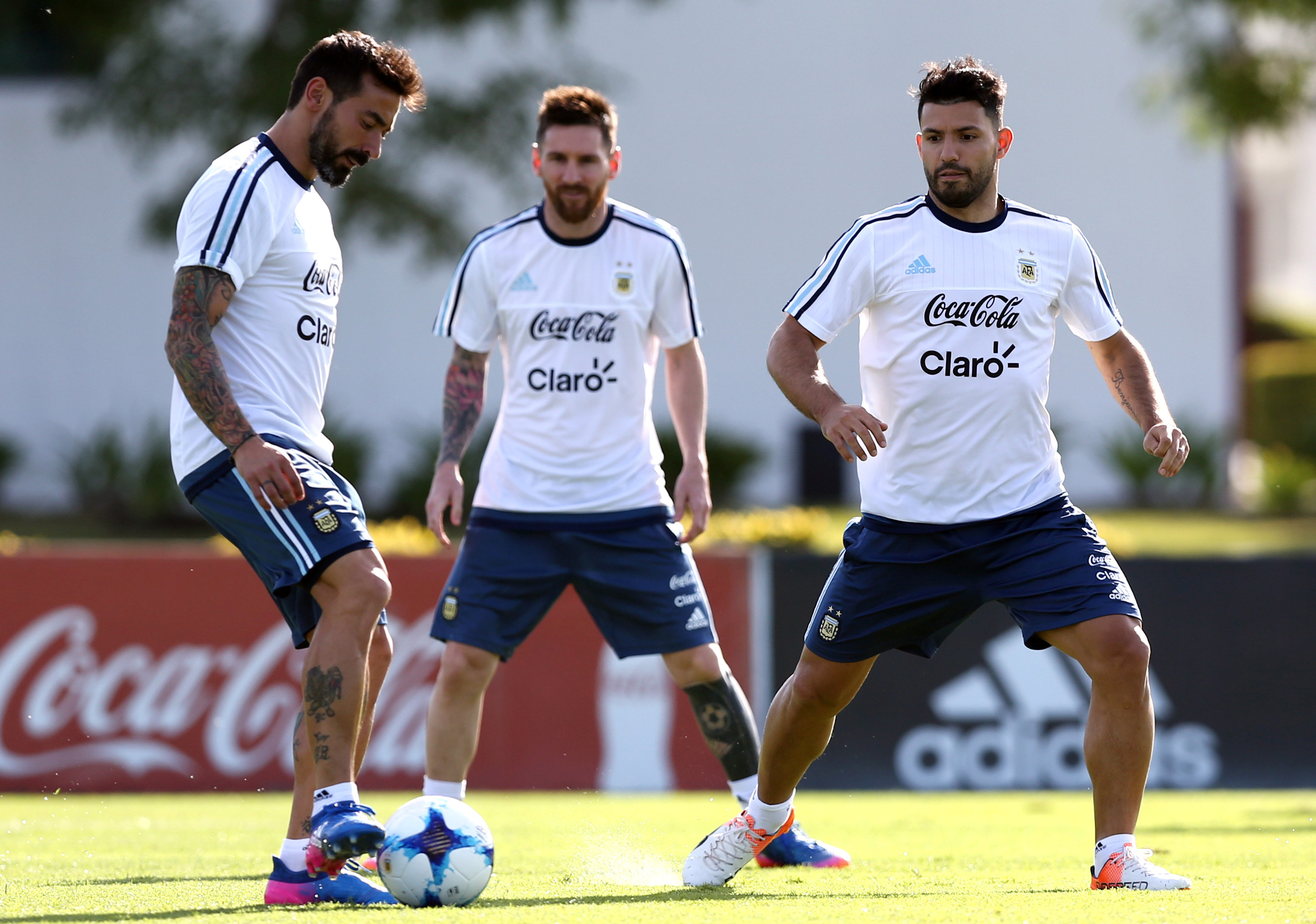 argentina 039 s ezequiel lavezzi l kicks the ball next to sergio aguero and lionel messi during a training session ahead of their match against chile photo reuters