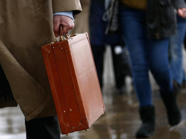 a worker holds his briefcase as he walks across london bridge in london february 28 2014 photo reuters