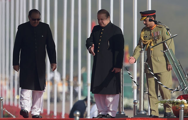 prime minister nawaz sharif c guides president mamnoon hussain l during a pakistan day military parade in islamabad on march 23 2017 photo afp