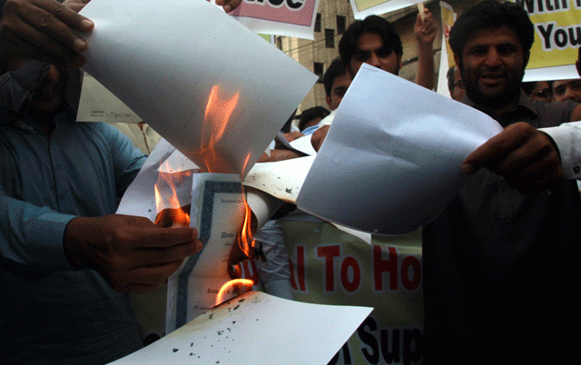 shouting slogans and holding placards against the government the candidates burnt their degrees while asking chief justice of pakistan to review the decision photo athar khan shouting slogans and holding placards against the government the candidates burnt their degrees while asking chief justice of pakistan to review the decision photo athar khan
