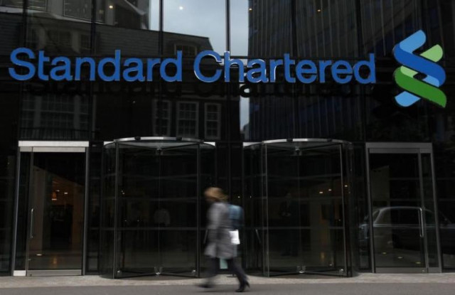 a woman walks past a standard chartered bank in london october 13 2010 photo reuters a woman walks past a standard chartered bank in london october 13 2010 photo reuters
