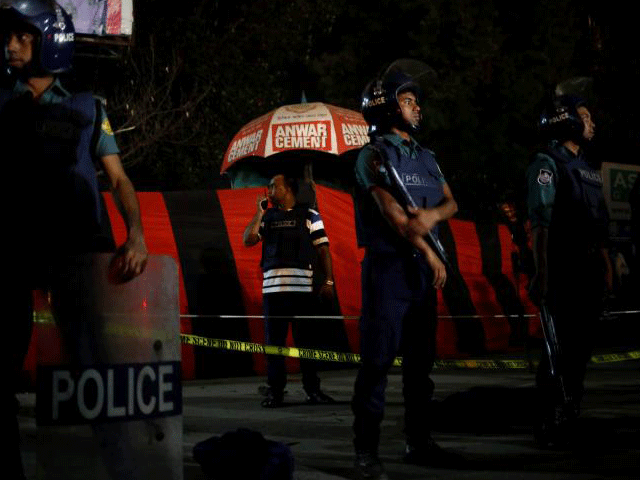 a security personnel talks over a walky talky while others stand guard in front of the spot where a suicide bomber blew himself up near the shahjalal international airport in dhaka bangladesh march 24 2017 photo reuters