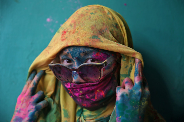 a woman poses for a photograph during holi celebrations in the town of barsana in the state of uttar pradesh photo reuters a woman poses for a photograph during holi celebrations in the town of barsana in the state of uttar pradesh photo reuters