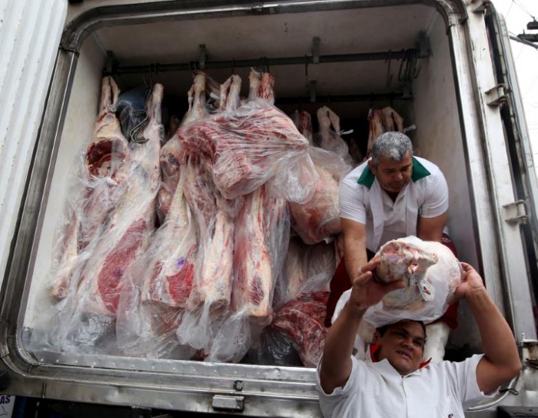 workers unload packed meat from a truck in sao paulo june 3 2015 photo reuters