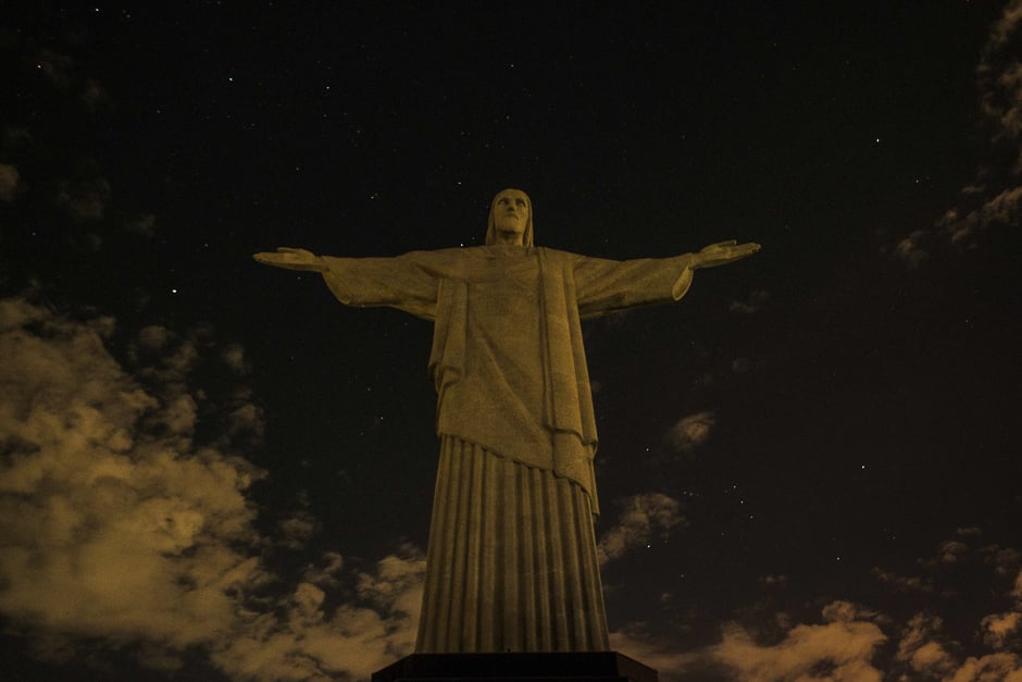 the statue of christ the redeemer is seen after being plunged into darkness for the earth hour environmental campaign on top of corcovado hill in rio de janeiro brazil photo afp