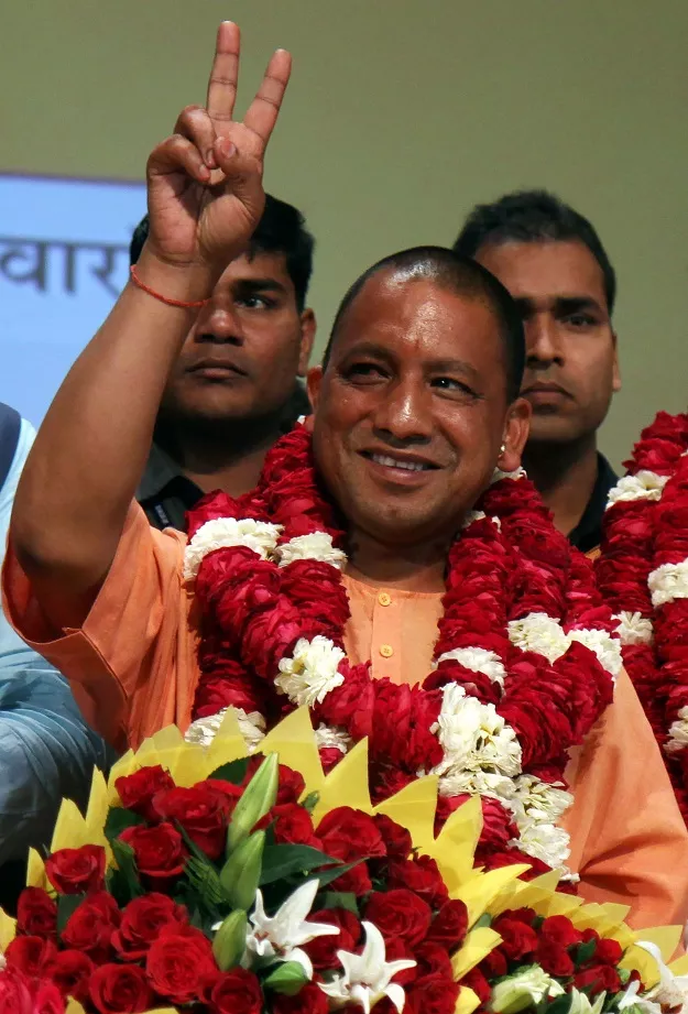 in this photograph taken on march 18 2017 new chief minister of the northern indian state of uttar pradesh yogi adityanath gestures to supporters as he is presented with a floral bouquet during a ceremony in lucknow photo afp in this photograph taken on march 18 2017 new chief minister of the northern indian state of uttar pradesh yogi adityanath gestures to supporters as he is presented with a floral bouquet during a ceremony in lucknow photo afp