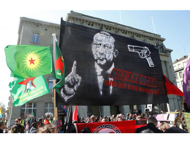 people hold banners and flags during a demonstration against erdogan dictatorship and in favour of democracy in turkey in bern switzerland march 25 2017 photo reuters