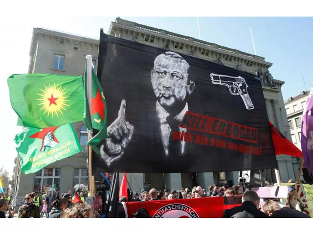people hold banners and flags during a demonstration against erdogan dictatorship and in favour of democracy in turkey in bern switzerland march 25 2017 photo reuters people hold banners and flags during a demonstration against erdogan dictatorship and in favour of democracy in turkey in bern switzerland march 25 2017 photo reuters