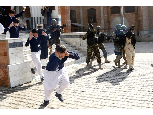 school children flee as soldiers conducting an exercise to repel militant attacks detain a mock militant r at the islamia collegiate school in peshawar pakistan february 2016 photo reuters