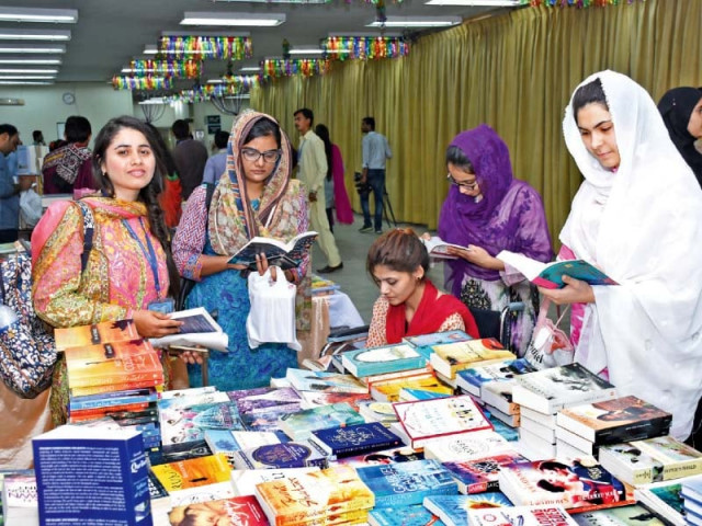 participants sift through books during the fair photo express participants sift through books during the fair photo express
