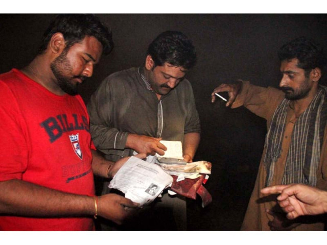 people go through papers found at the wreck site to determine identities of the victims photo abid nawaz people go through papers found at the wreck site to determine identities of the victims photo abid nawaz