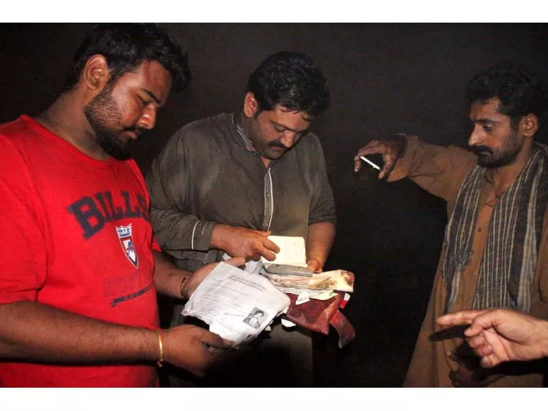 people go through papers found at the wreck site to determine identities of the victims photo abid nawaz people go through papers found at the wreck site to determine identities of the victims photo abid nawaz