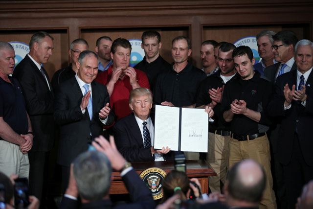 u s president donald trump holds up an executive order on quot energy independence quot eliminating obama era climate change regulations during a signing ceremony at the environmental protection agency epa headquarters in washington us march 28 2017 photo reuters