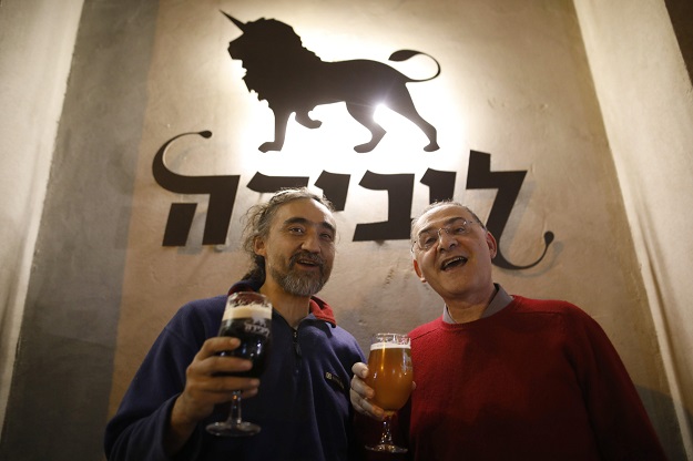 arik salarov l and leonid lipkin the owners of the libira brewery pub pose for a photograph at their brewery in the northern israeli city of haifa on february 23 2017 photo afp