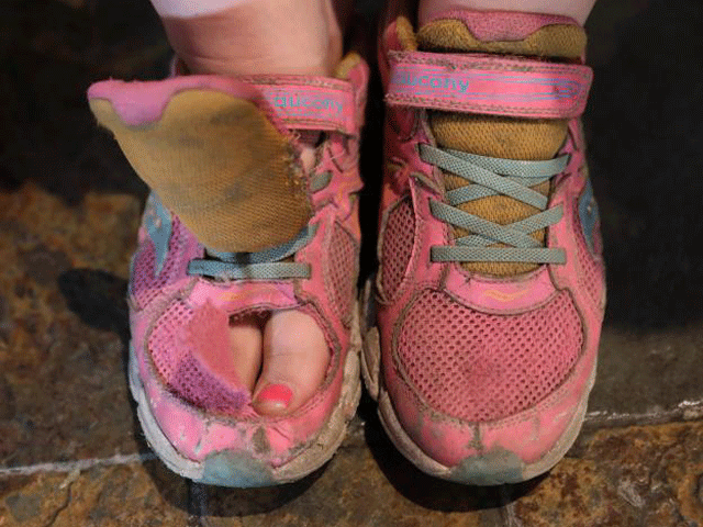 shannon winckler from wheaton illinois sits before her shoes are judged during the odor eater 039 s rotten sneaker contest at ripley 039 s believe it or not times square in new york us march 28 2017 photo reuters