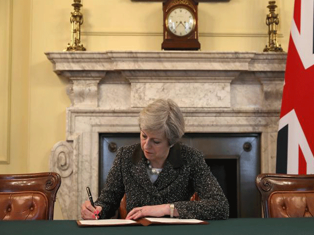 british pm theresa may in the cabinet office signs the official letter to european council president donald tusk invoking article 50 and the uk 039 s intention to leave the eu on march 28 2017 in london photo reuters