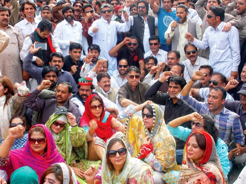 pti leader asad umer sits with protesters demanding water supply photo waseem nazir express