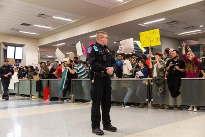 police maintain walkways as people gather to protest against the travel ban imposed by u s president donald trump 039 s executive order at dallas fort worth international airport in dallas texas u s january 28 2017 photo reuters