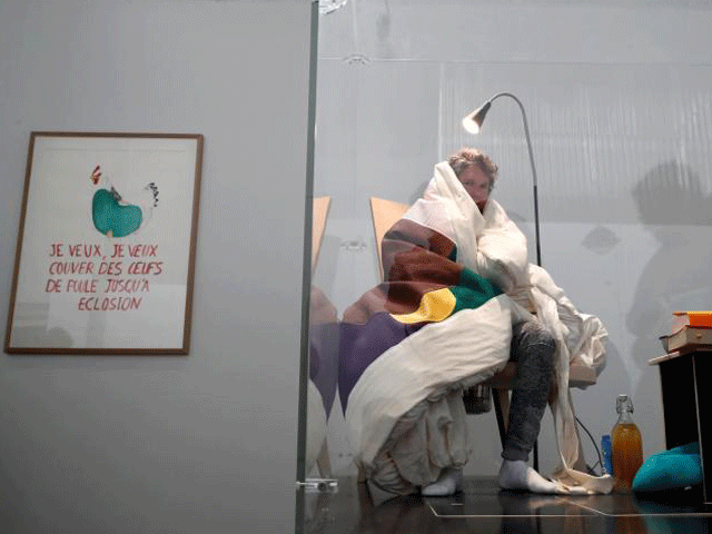 french artist abraham poincheval is seen in a vivarium on the first day of his performance in an attempt to incubate chicken eggs which takes from 21 to 26 days at the palais de tokyo museum in paris france march 29 2017 photo reuters