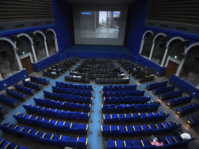 this picture taken on march 27 2017 shows spectators waiting for a film showing at the regal cinema an 84 year old movie hall in the heart of new delhi photo afp this picture taken on march 27 2017 shows spectators waiting for a film showing at the regal cinema an 84 year old movie hall in the heart of new delhi photo afp
