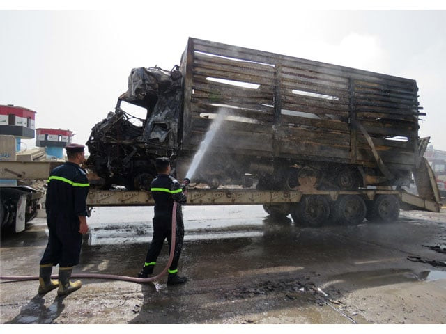 emergency services extinguish smoke rising from a truck the day after a suicide bombing targeting a checkpoint at a main southern entrance to baghdad on march 30 2017 photo afp emergency services extinguish smoke rising from a truck the day after a suicide bombing targeting a checkpoint at a main southern entrance to baghdad on march 30 2017 photo afp