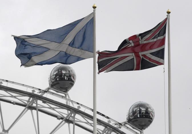 the british union flag r and a scottish saltire flag fly above the scottish office in whitehall with the london eye wheel seen behind in london britain march 14 2017 photo reuters