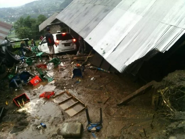 villagers attempt to salvage their belongings from a house damaged in a landslide in kintamani bali province photo afp villagers attempt to salvage their belongings from a house damaged in a landslide in kintamani bali province photo afp