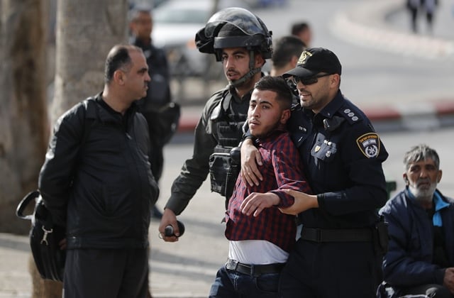 israeli security forces arrest a palestinian man in jerusalem 039 s old city following a stabbing attack on april 1 2017 photo afp