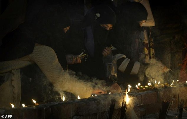 visiting shrines and offering alms to the poor   and cash to the custodians   remains very popular in the country photo afp