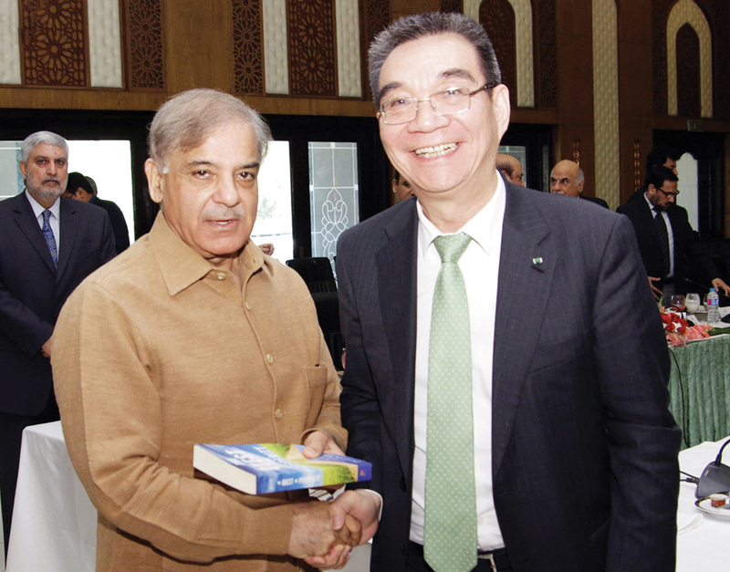 peking university s prof justin yifu lin presents his book to shehbaz sharif photo nni