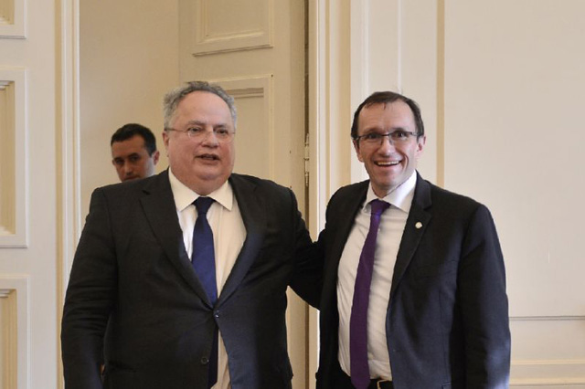 greek foreign minister nikos kotzias l poses with un envoy for cyprus espen barth eide prior their meeting in athens photo afp