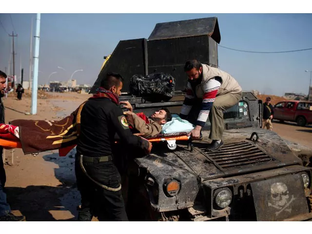 a wounded iraqi is evacuated as iraqi forces battle with islamic state militants in western mosul iraq march 24 2017 photo reuters a wounded iraqi is evacuated as iraqi forces battle with islamic state militants in western mosul iraq march 24 2017 photo reuters