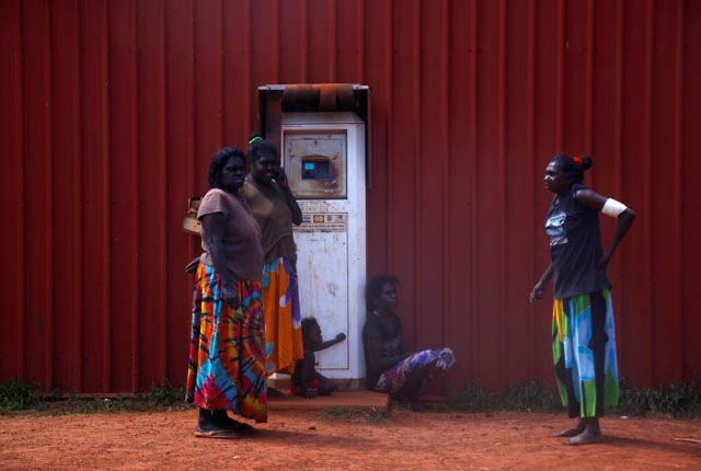 members of the australian aboriginal community of ramingining stand next to a machine used to pay for fuel in east arnhem land located east of the northern territory city of darwin photo reuters