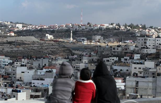 palestinian children sit overlooking the west bank refugee camp of jalazoun on the outskirts of ramallah photo afp