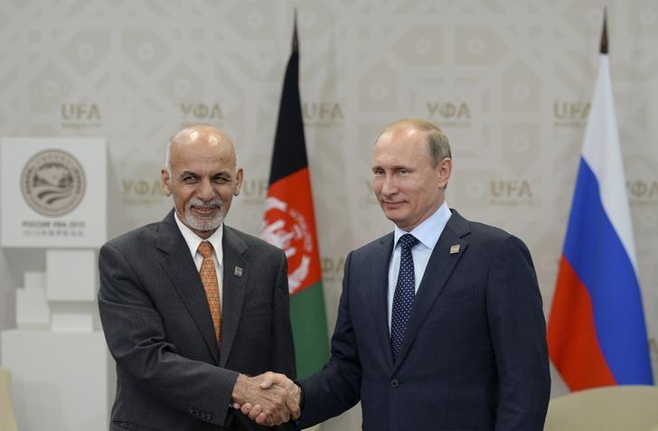 in this file photo russia 039 s president vladimir putin r shakes hands with afghanistan 039 s president ashraf ghani during the shanghai cooperation organization sco summit in ufa russia july 10 2015 photo reuters