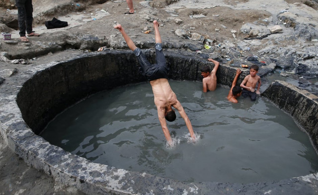 iraqis bathe in a sulphur pond in the hamam al alil area about 14 kilometres from the southern outskirts of mosul photo afp